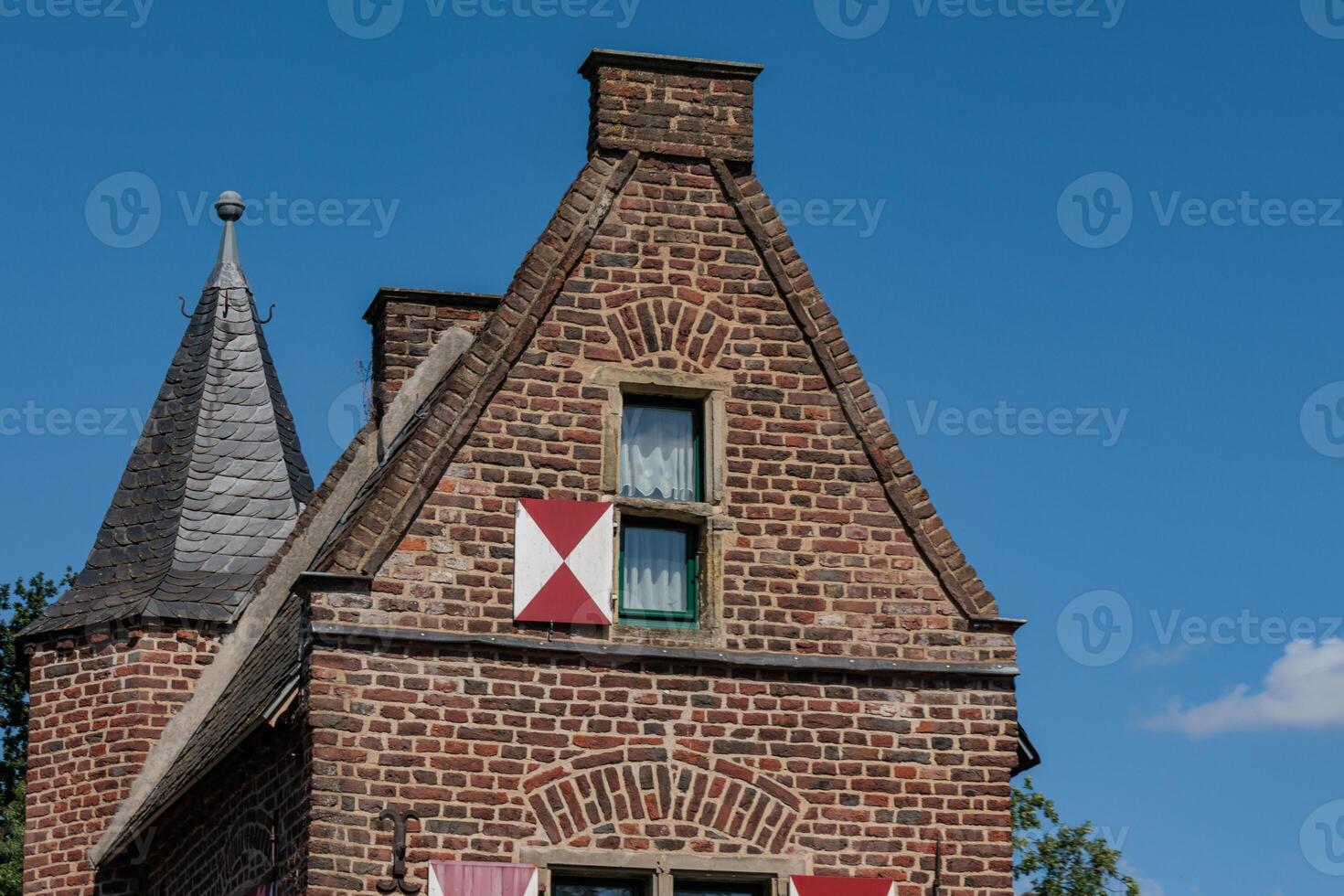 A large brick building with a smaal window in xanten photo