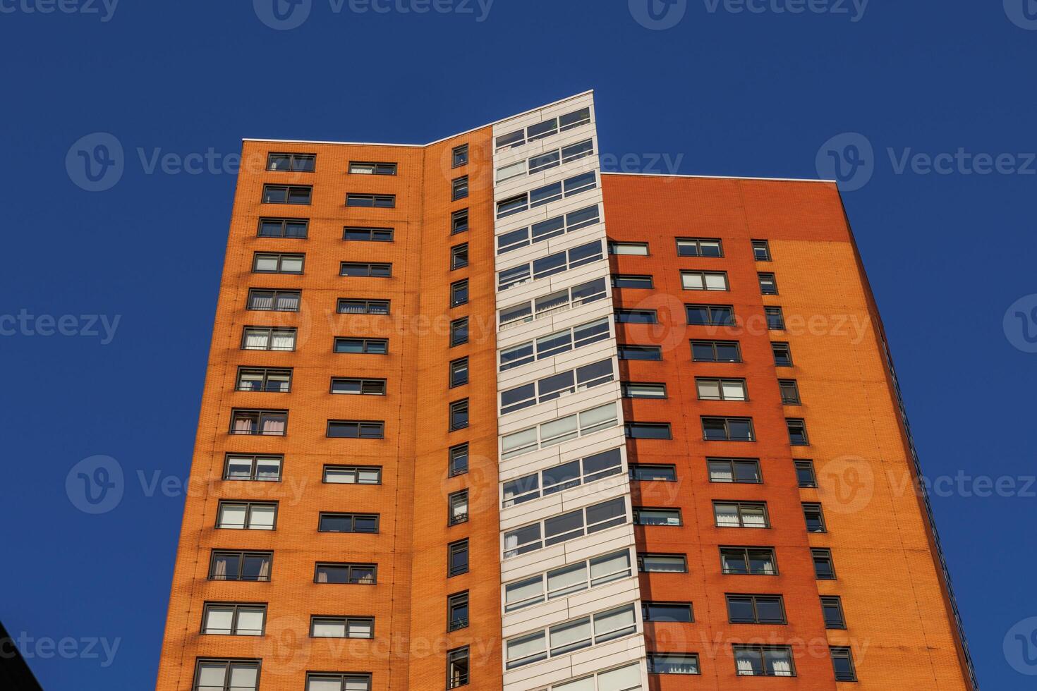 A tall building with a clock on it in rotterdam holland photo