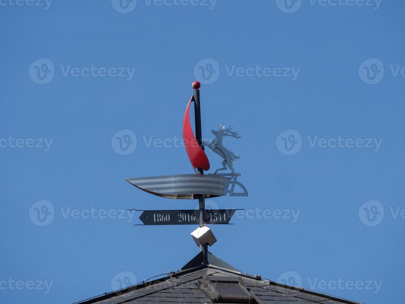 A weather vane on top of a building photo