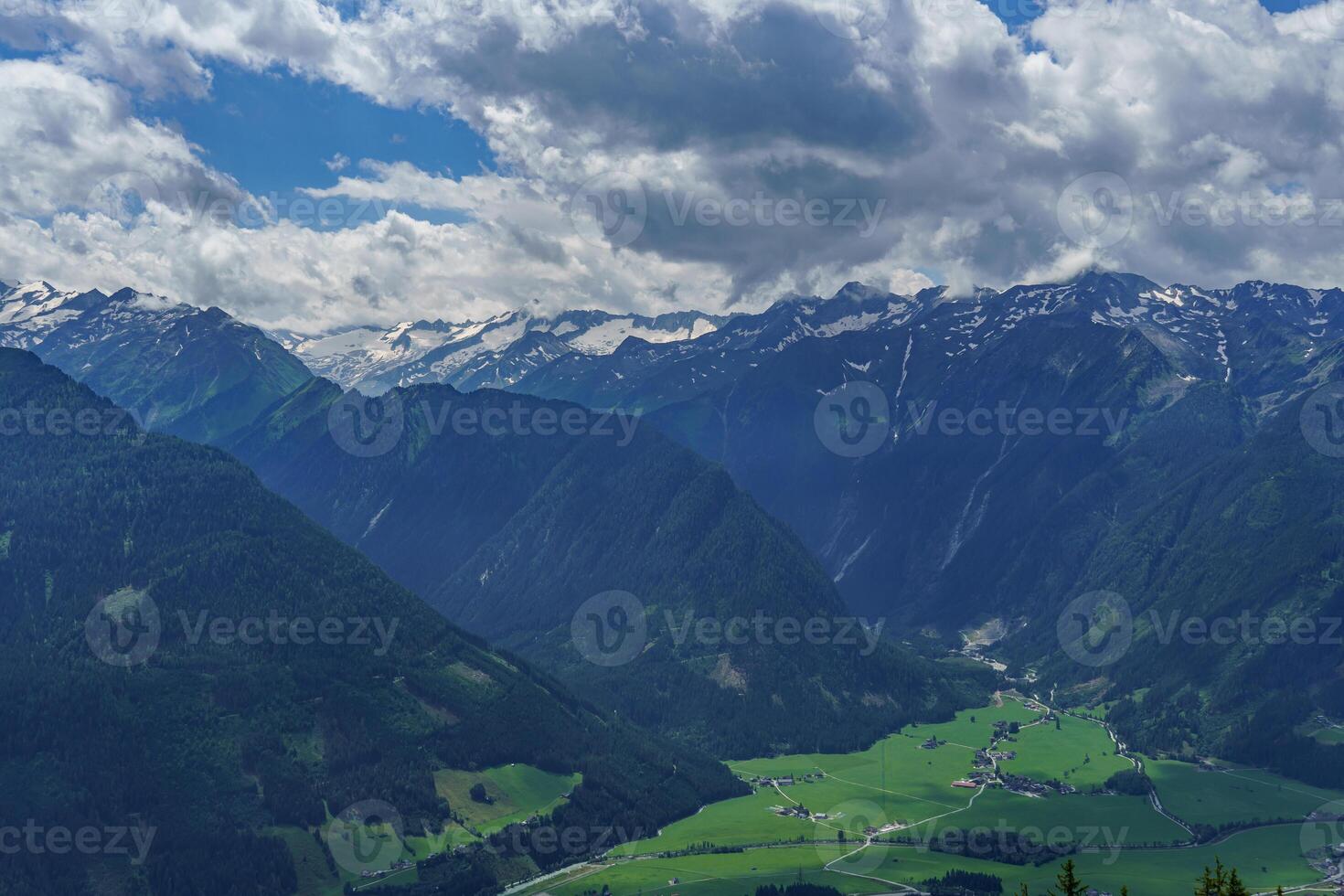 A view of a valley with a mountain range in the background photo