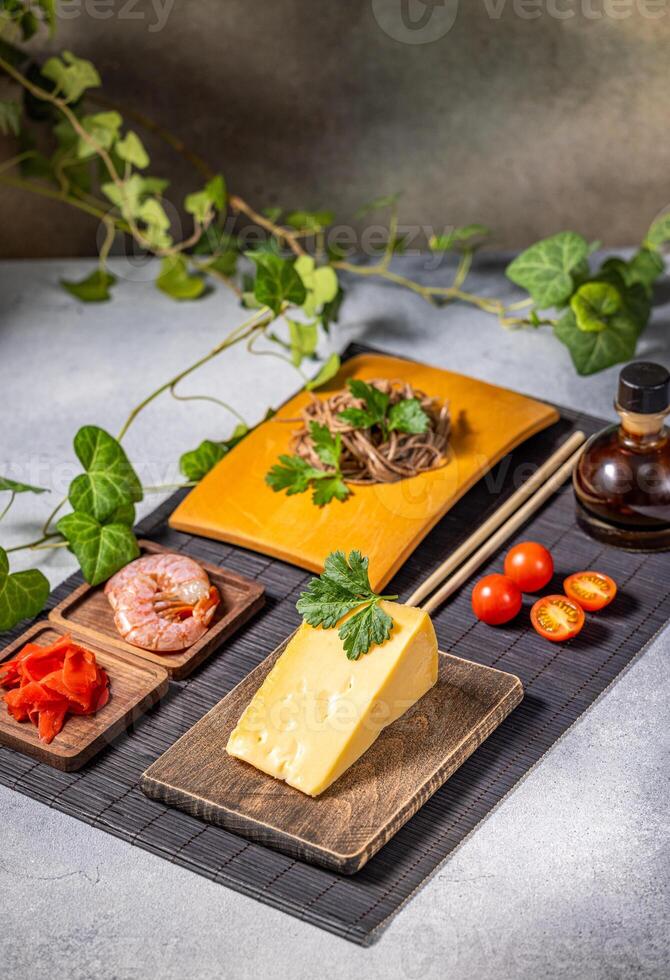 Soba noodles, cheese, shrimp and cherry tomatoes creating delicious fusion cuisine photo