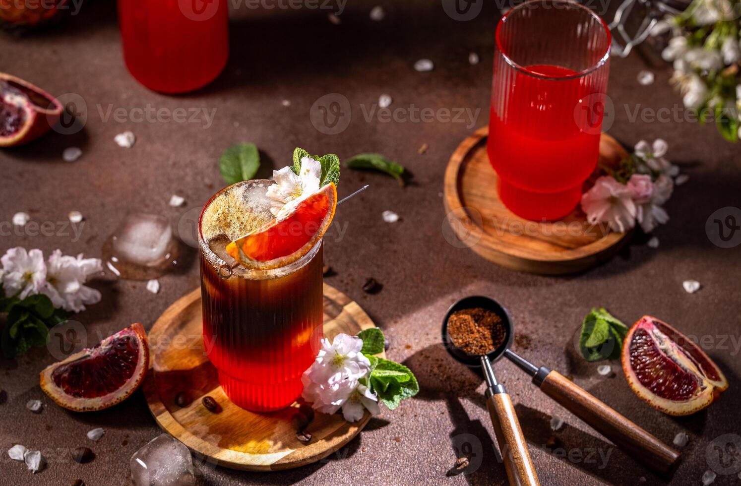 Refreshing espresso and blood orange cocktail decorated with blossoms photo