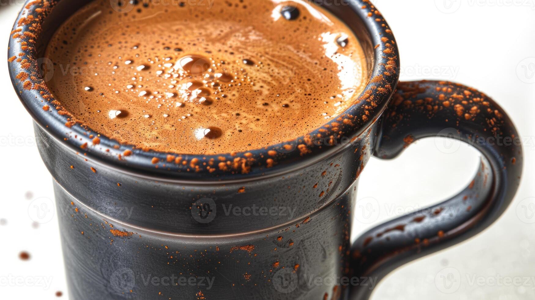 Close-up of a steaming cup of coffee with a cinnamon rim photo