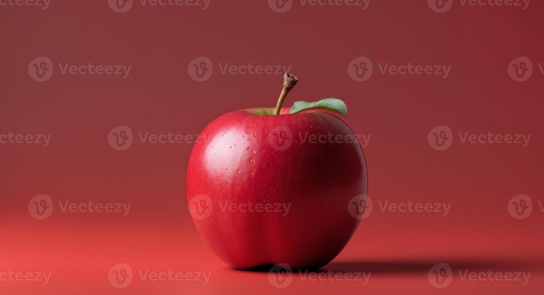 Vibrant red apple on matching background for freshness and simplicityVibrant red apple on matching background for freshness and simplicity. photo