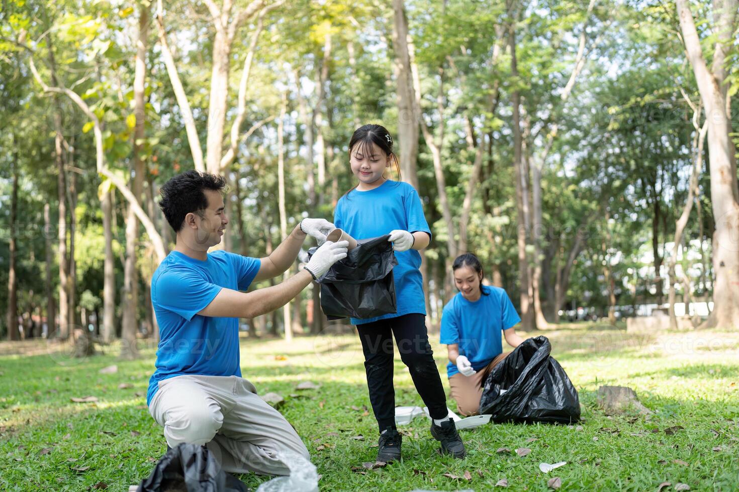 Family enjoying a fun and rewarding garbage collection experience in a vibrant park photo