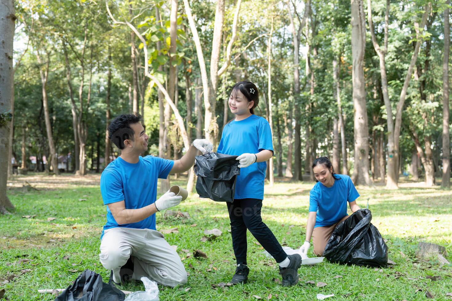 Family enjoying a collaborative garbage collection effort in a beautiful park photo