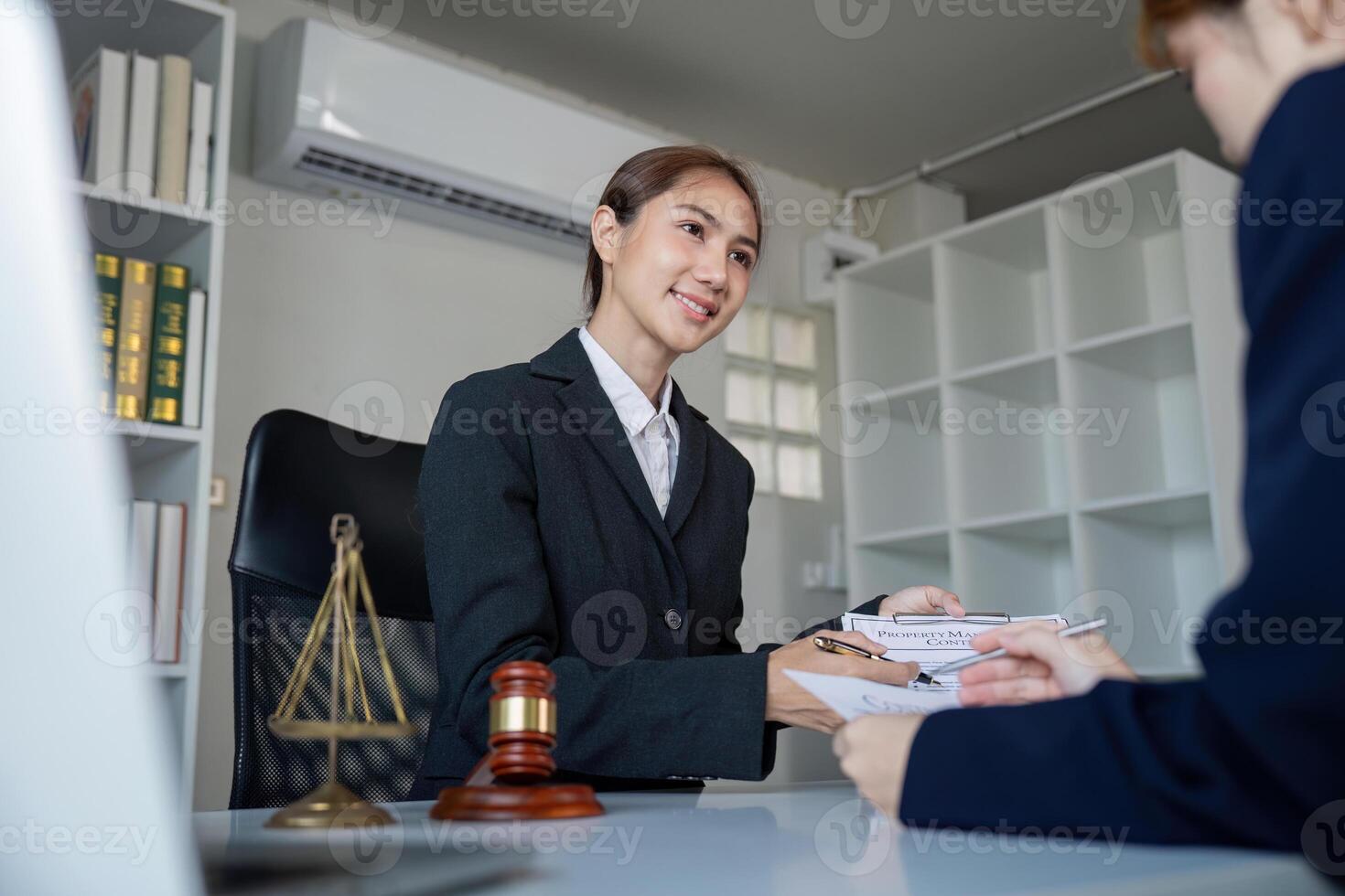 Lawyer consulting with a client, discussing legal documents in a professional office setting photo