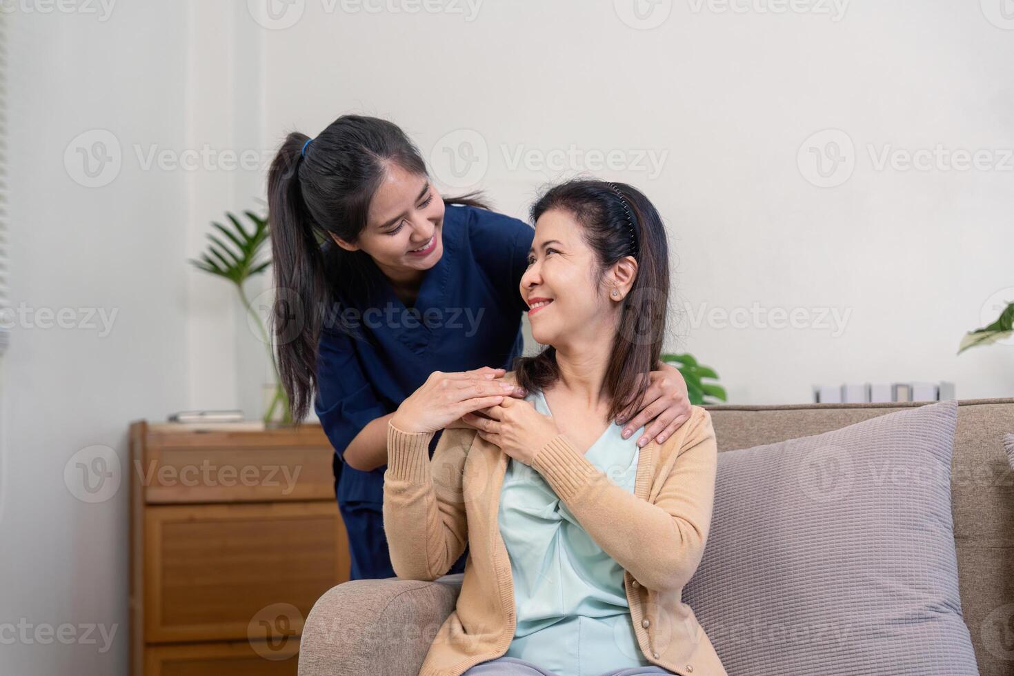 Empathetic caregiver offering gentle support and companionship to elderly client in a cozy home setting photo