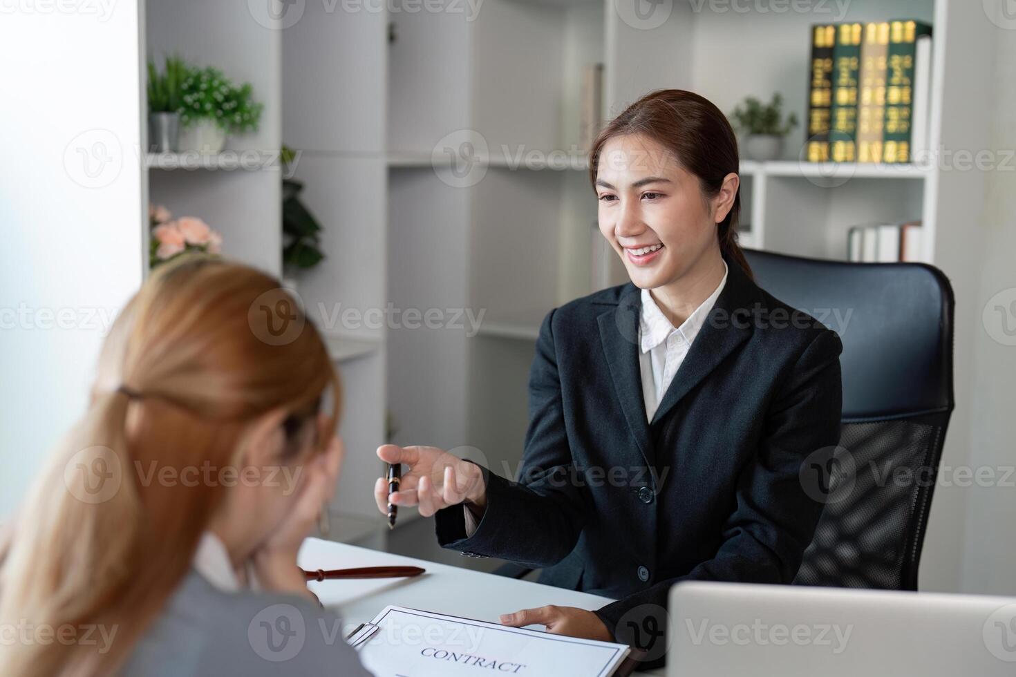 Lawyer explaining contract terms to a client during a professional consultation in an office photo