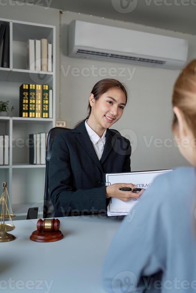 Lawyer presenting a contract to a client during a professional consultation in an office photo