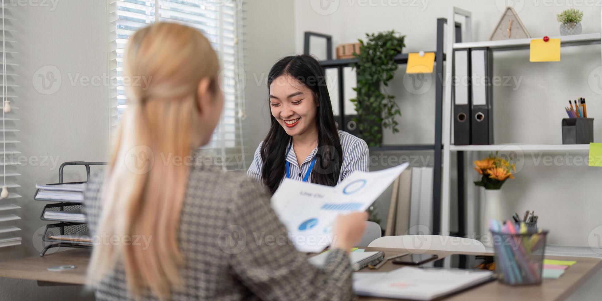 Business team members discussing data insights and reports in a bright office photo