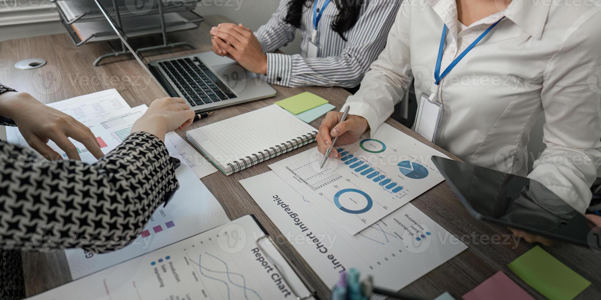 Business team analyzing charts and data reports in a collaborative workspace photo