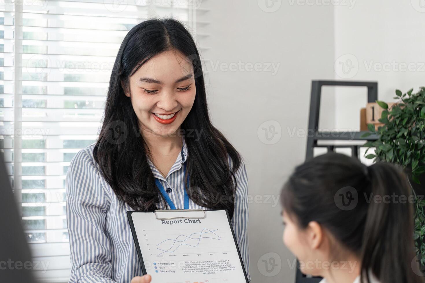 Business professional sharing a report chart with a colleague in an office setting photo