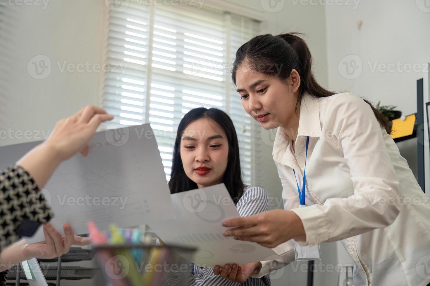 Business team analyzing data reports and collaborating in a modern office photo