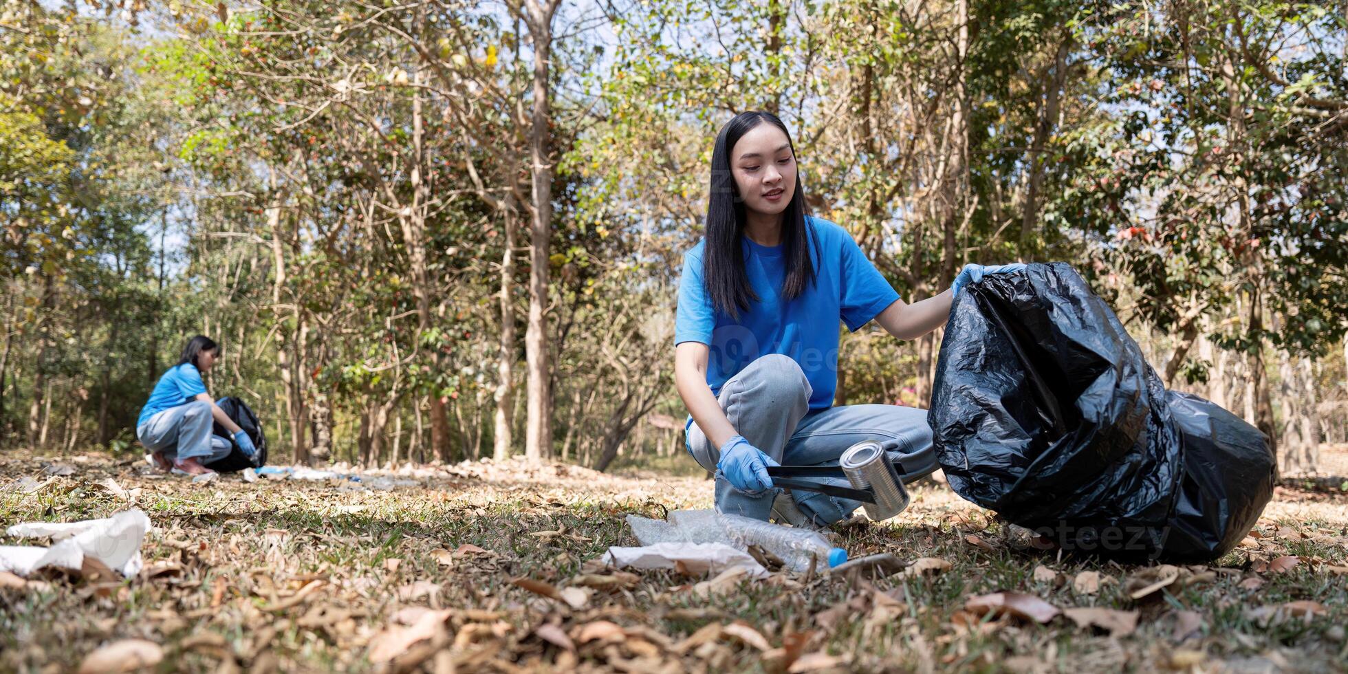 Volunteer collecting trash in a forest, emphasizing environmental responsibility and community service photo