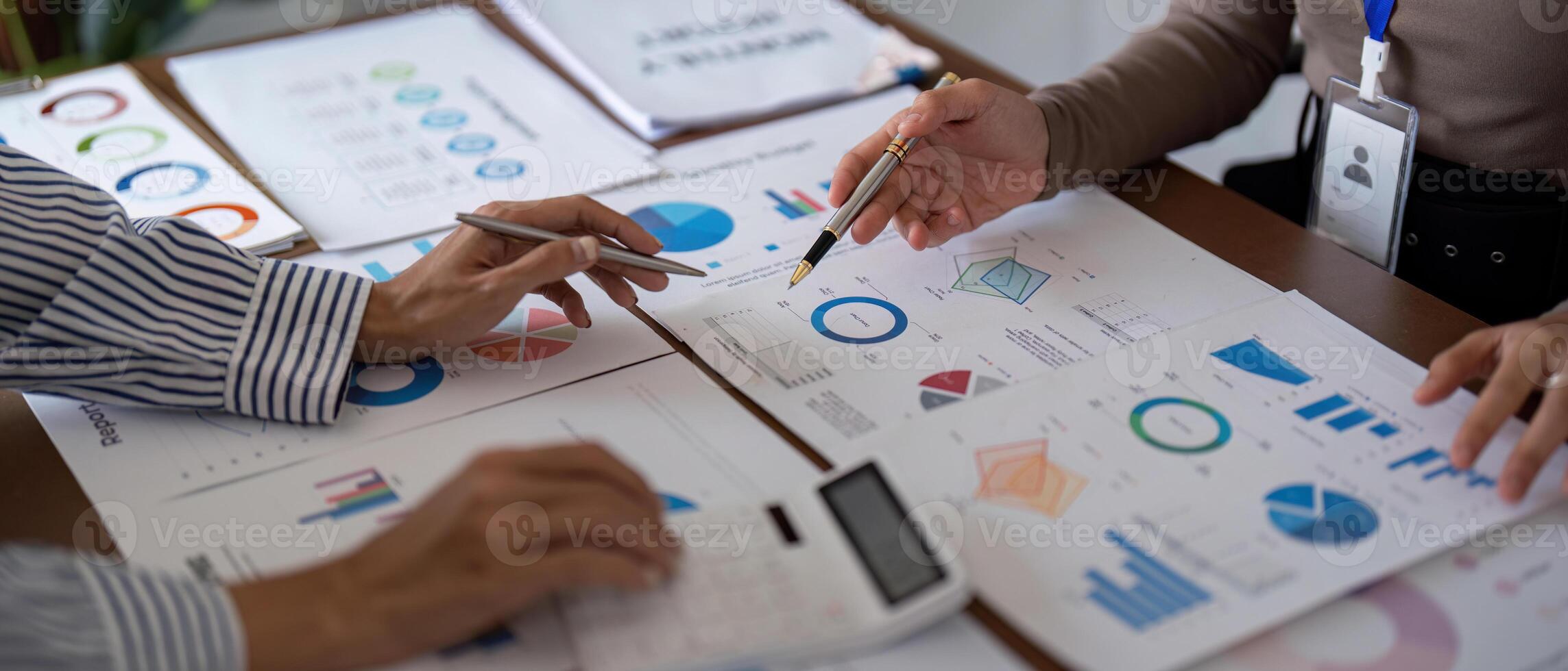 Business team collaborating on financial analysis with charts and graphs during a strategy meeting photo