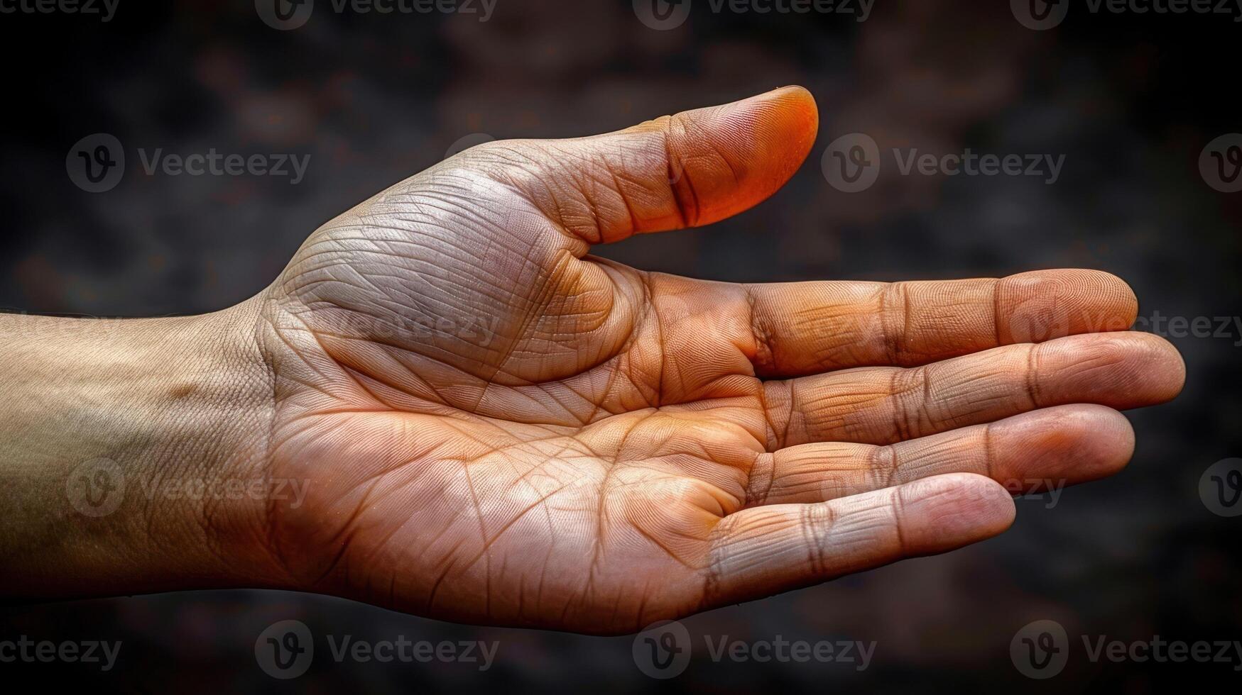 A close-up of a hand reaching out, fingers slightly curled, with sun-kissed skin photo