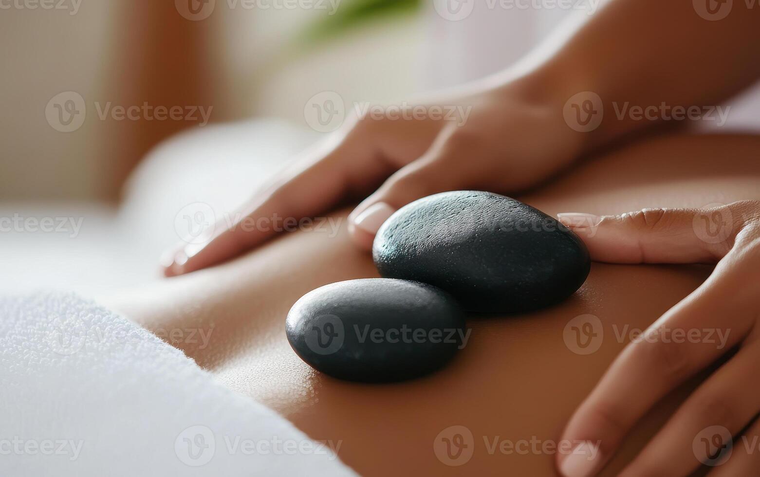 Relaxing spa treatment with hot stones placed on person back, promoting tranquility and wellness. serene atmosphere enhances overall experience of relaxation and rejuvenation photo
