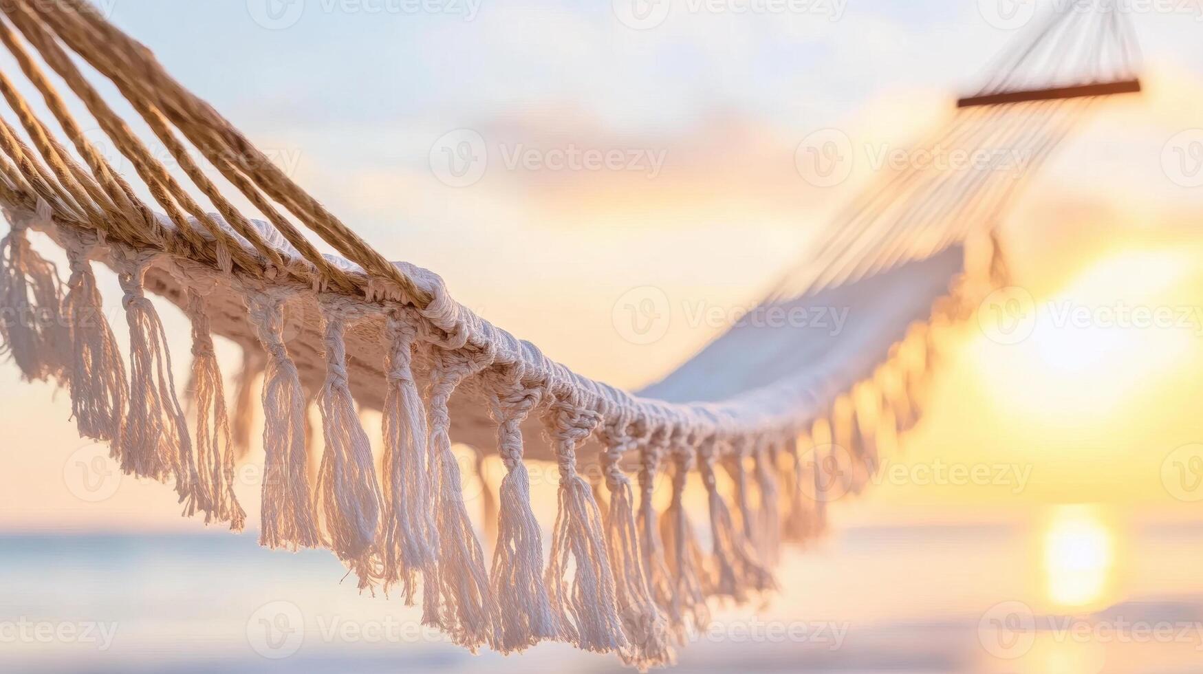 serene hammock with fringes swaying gently at sunset, surrounded by tranquil beach atmosphere. Perfect for relaxation and enjoying nature beauty photo