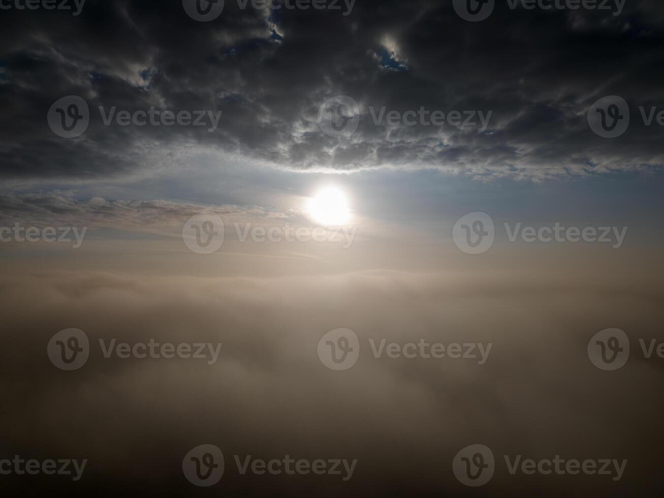 Tranquil and serene ethereal sunrise above the clouds with mist and mystery photo
