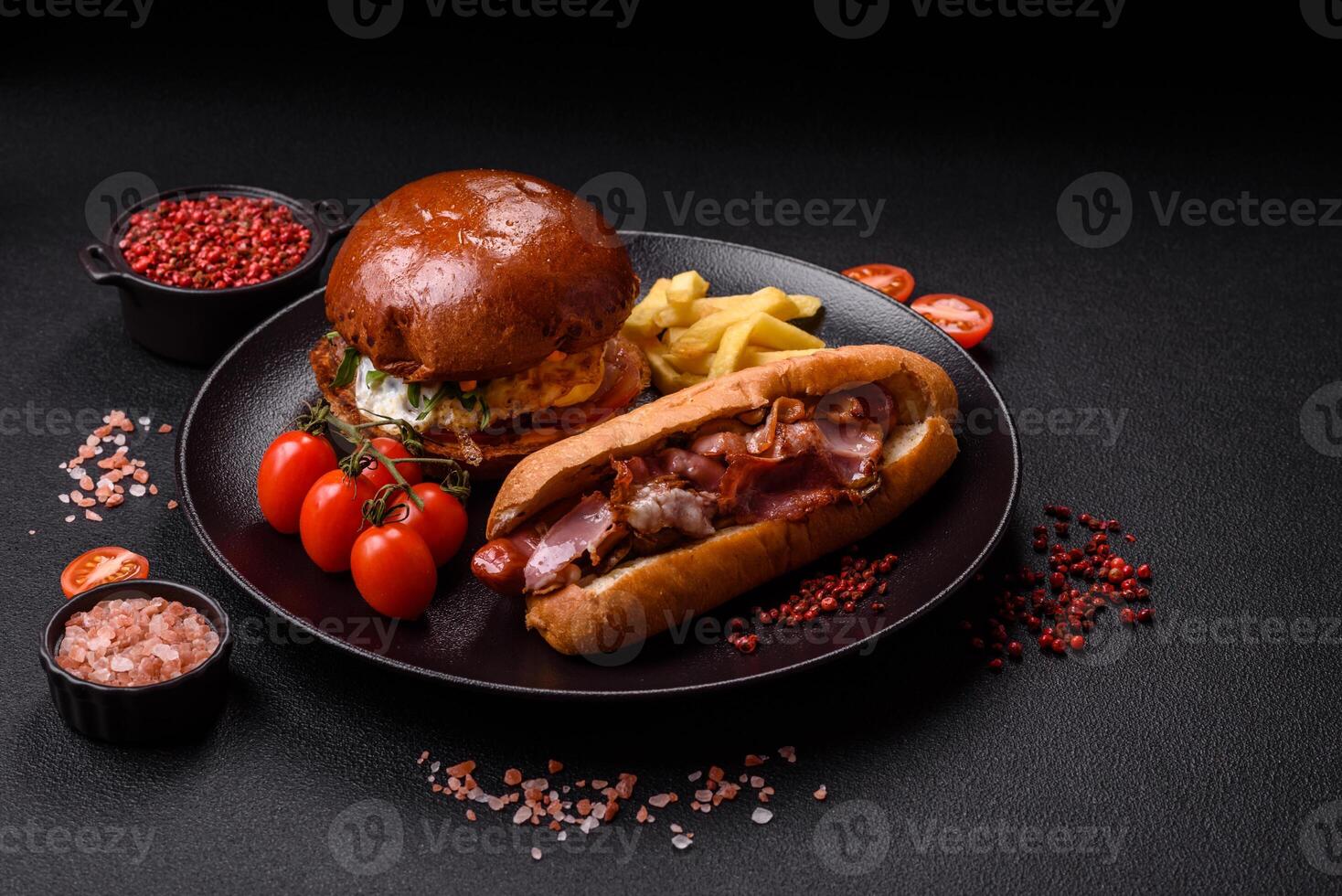 Delicious juicy hot dog with sausage, bacon, sauce, salt and spices s photo