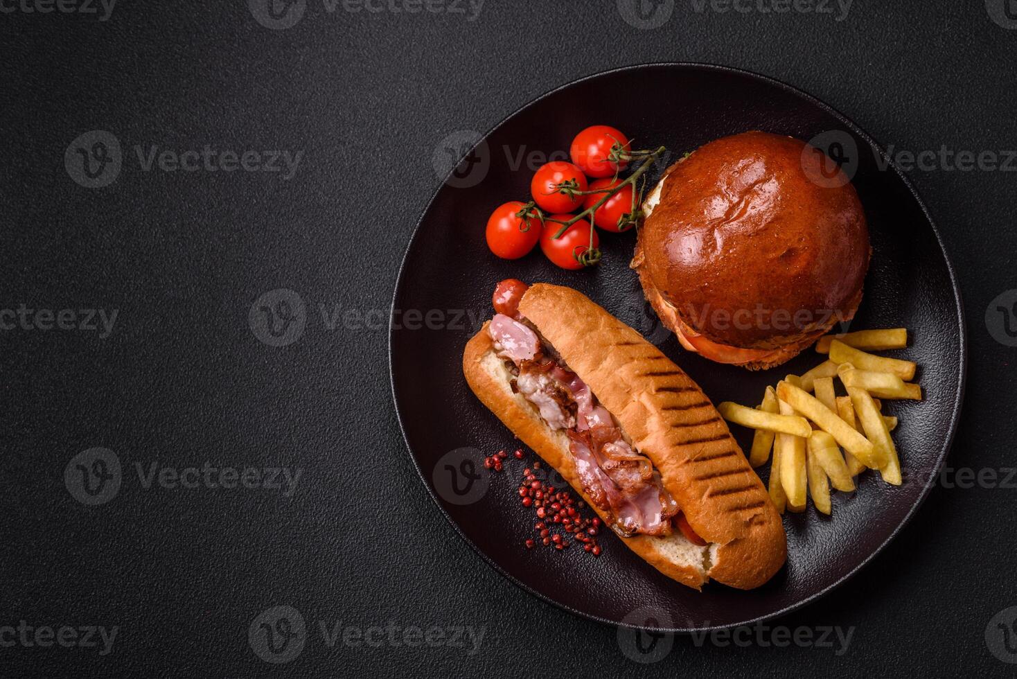 Delicious juicy hot dog with sausage, bacon, sauce, salt and spices j photo