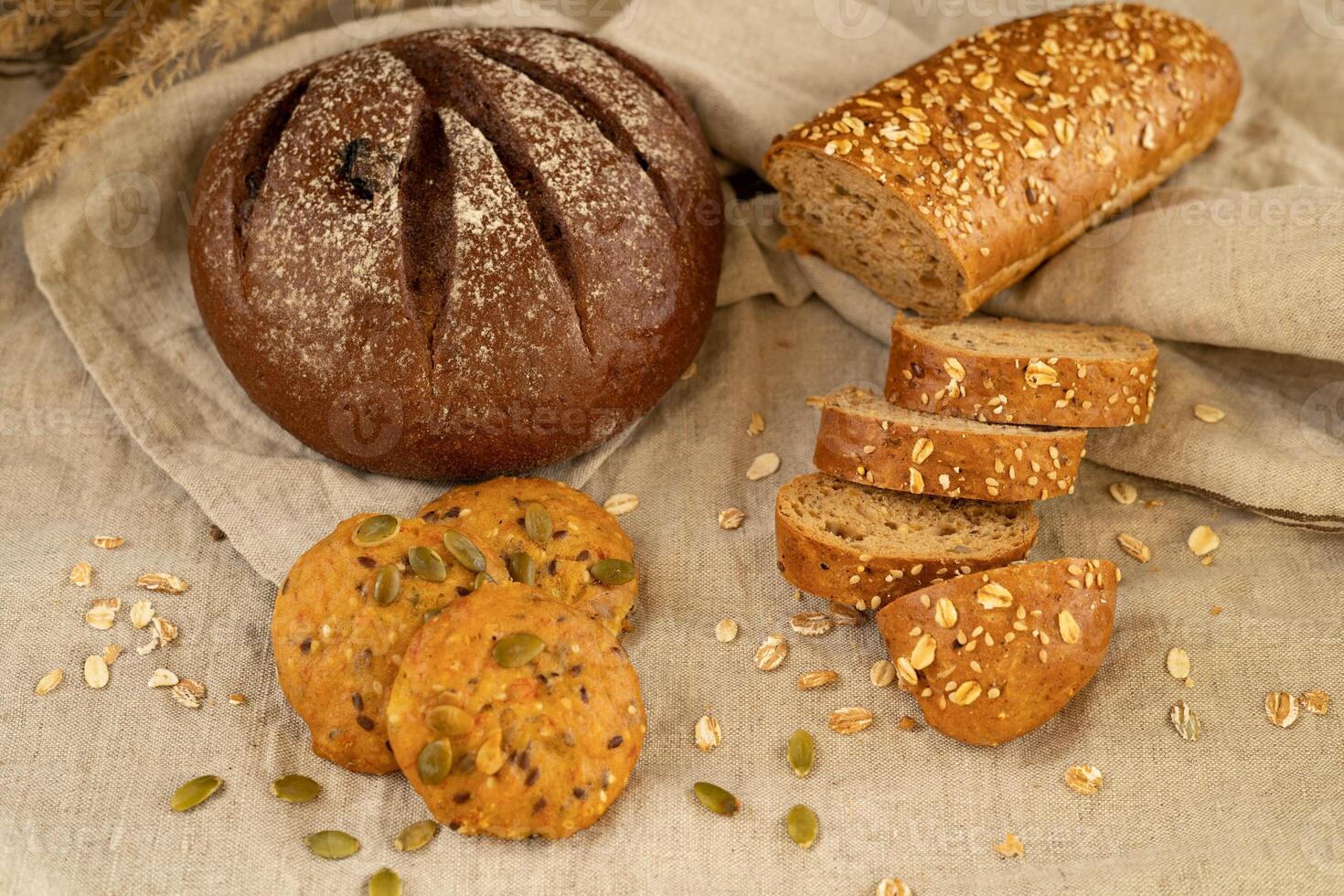 Lean rye bread, homemade cookies with pumpkin sesame linseed seeds, cereal baguette with sunflower seeds photo