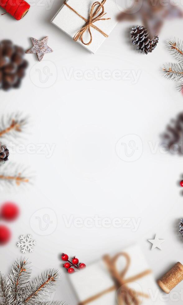 Rustic Christmas decorations in simple red and white tones on a white vertical background, featuring an empty space for text or holiday messages photo