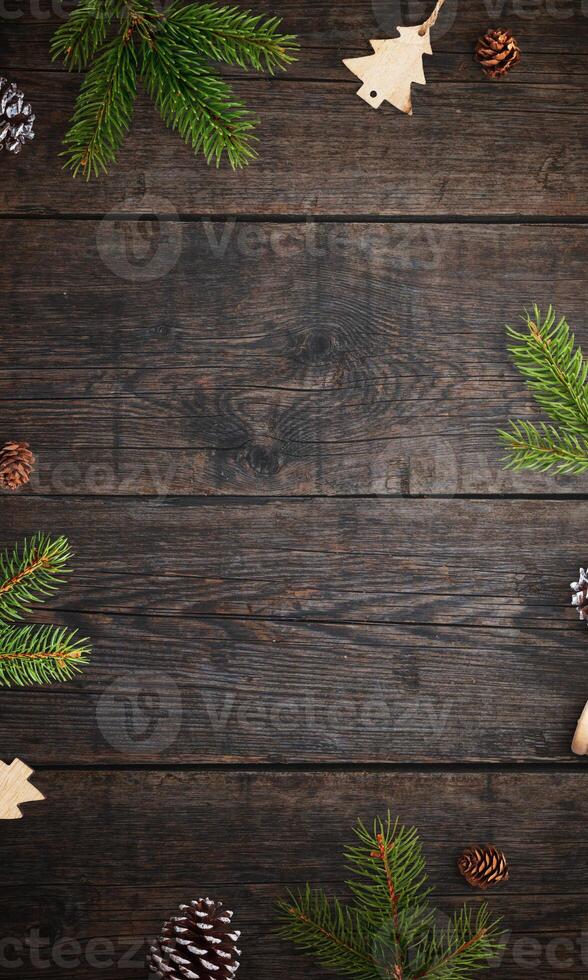 Rustic wooden table with Christmas branches and decorations, top view flat lay, featuring an empty space for a holiday greeting or festive message photo