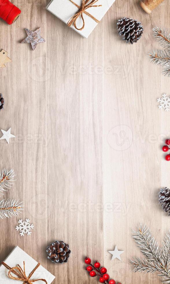 Top view Christmas composition with gifts and decorations at the top and bottom, featuring an empty space in the center, perfect for holiday greetings photo