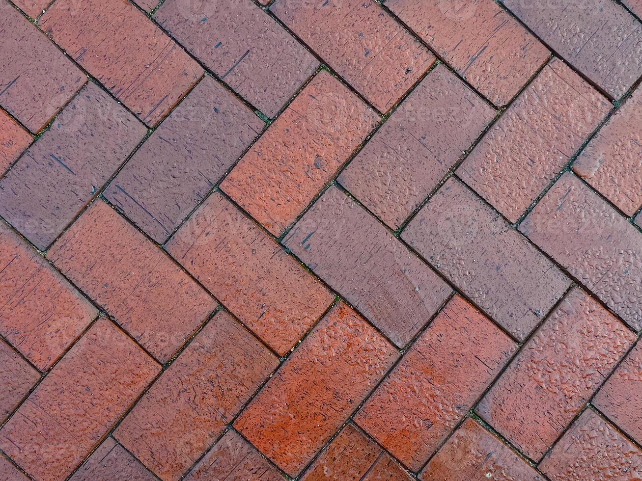 Herringbone brick pattern with red and brown bricks, showcasing a diagonal photo
