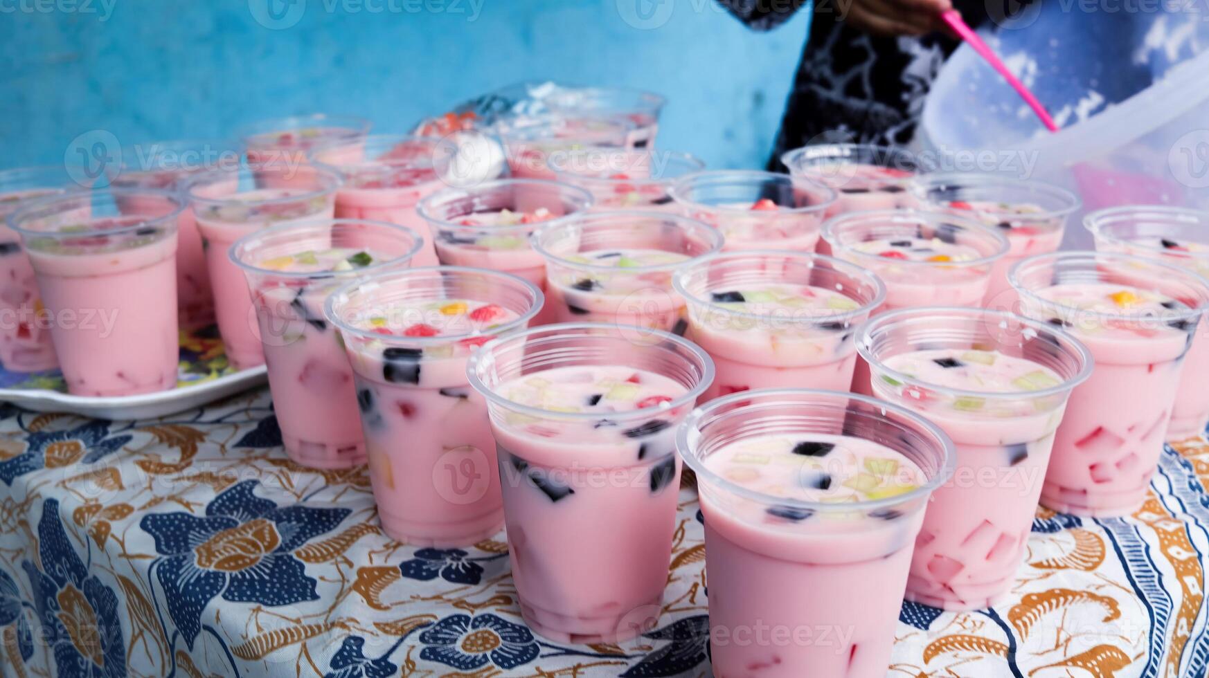 Fruit ice in plastic cups ready to be distributed at activities photo