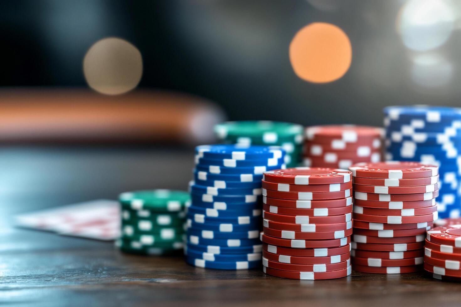 A close-up of colorful poker chips stacked on a table. photo
