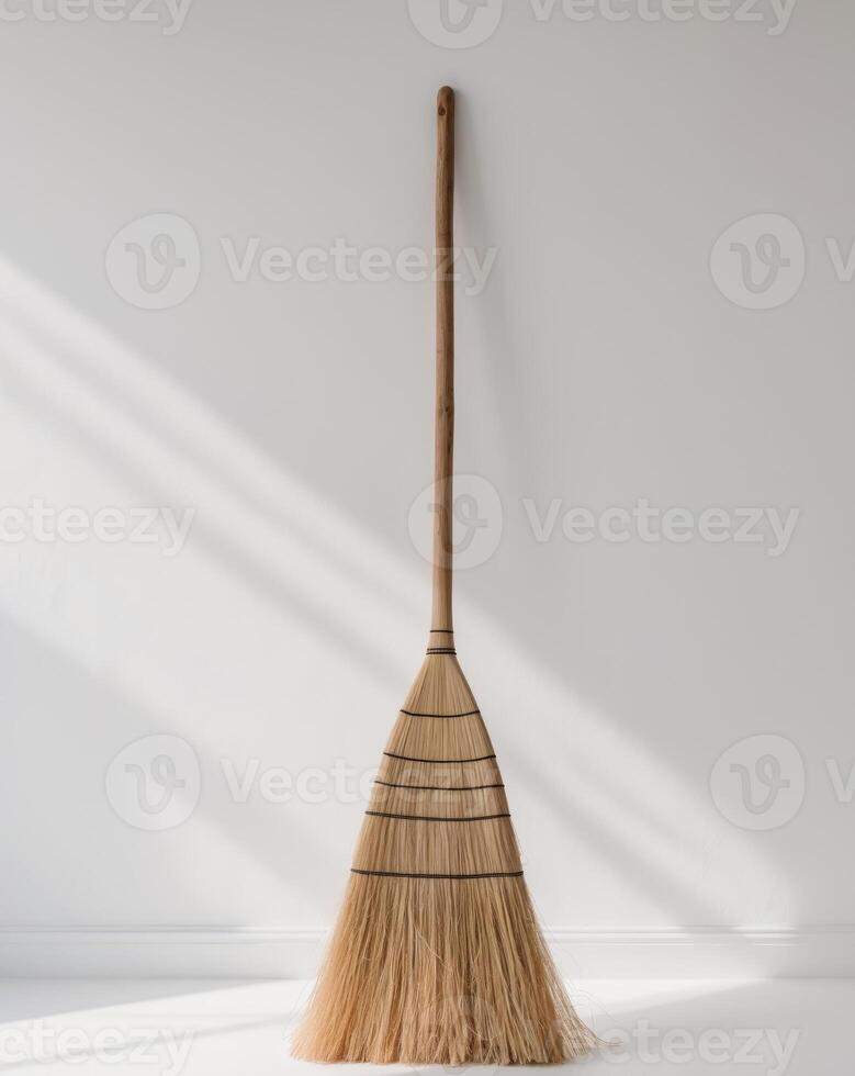 Wooden broom with a natural straw bristle. photo