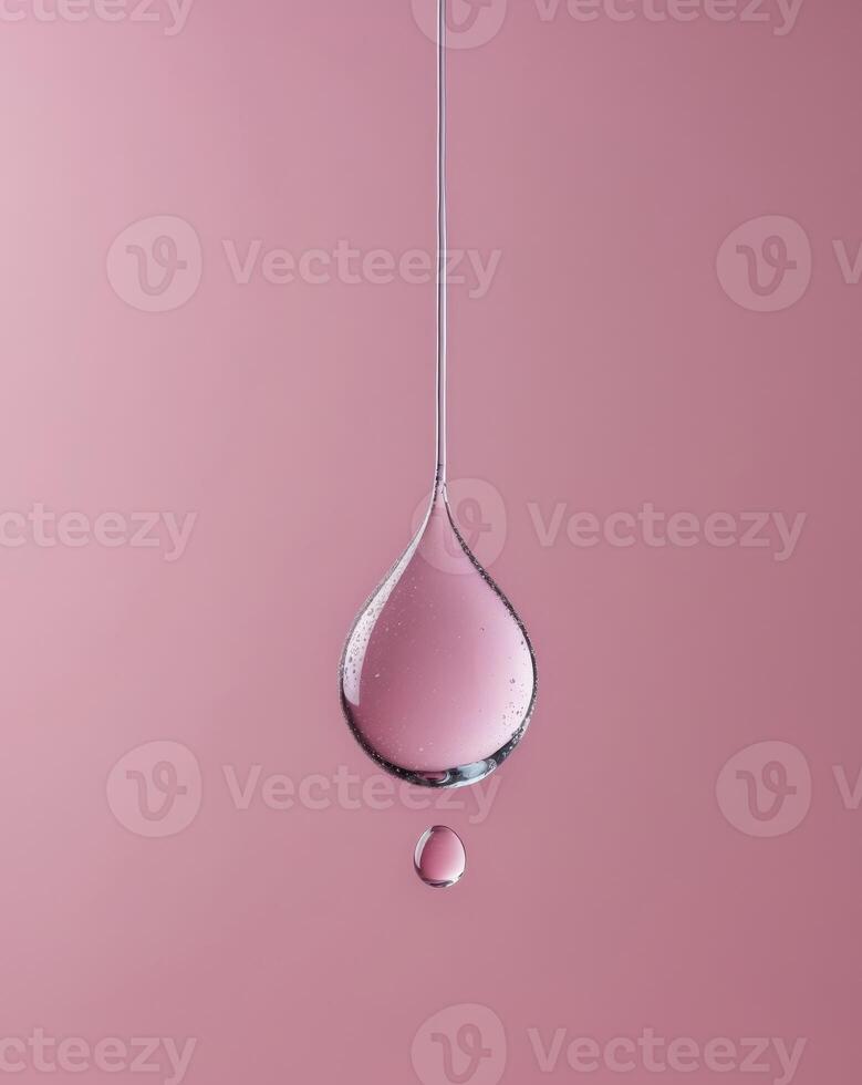 A pink background with a drop of water hanging from the ceiling photo
