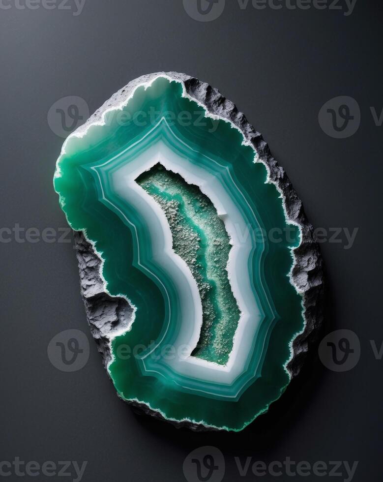 A close up of a green and white agate on a black backgroundA close up of a green and white agate on a black background. photo