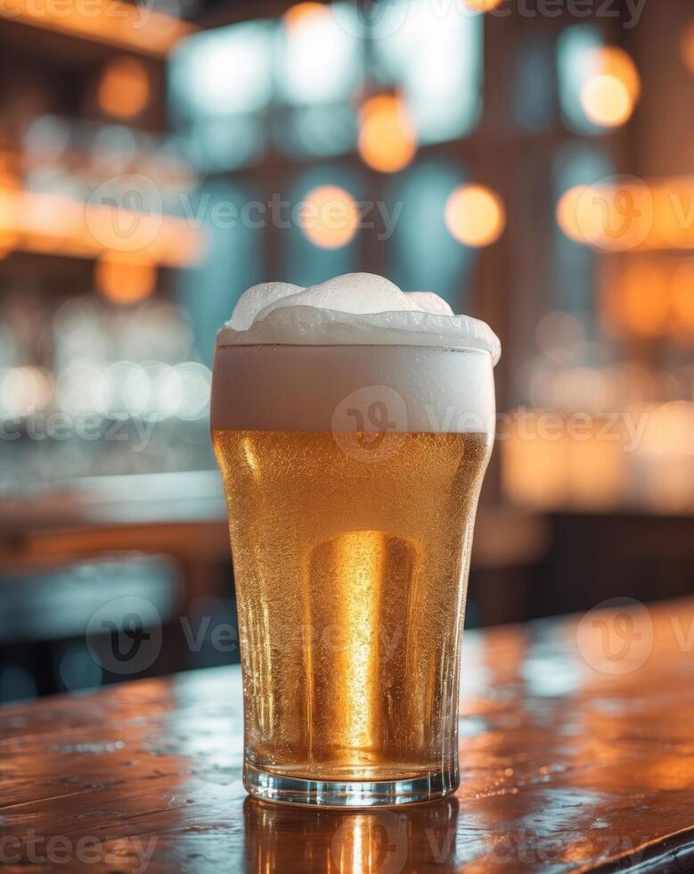 Frosty beer glass with rich foam on a bar table with warm ambient lighting in the background photo