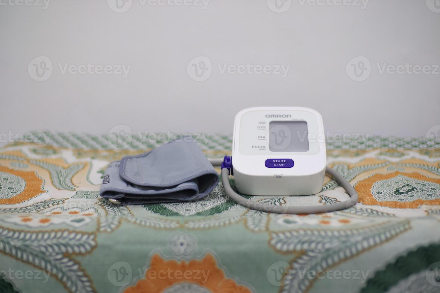 Lampung Selatan, september 13, 2024, Blood Pressure Monitor on patterned surface photo