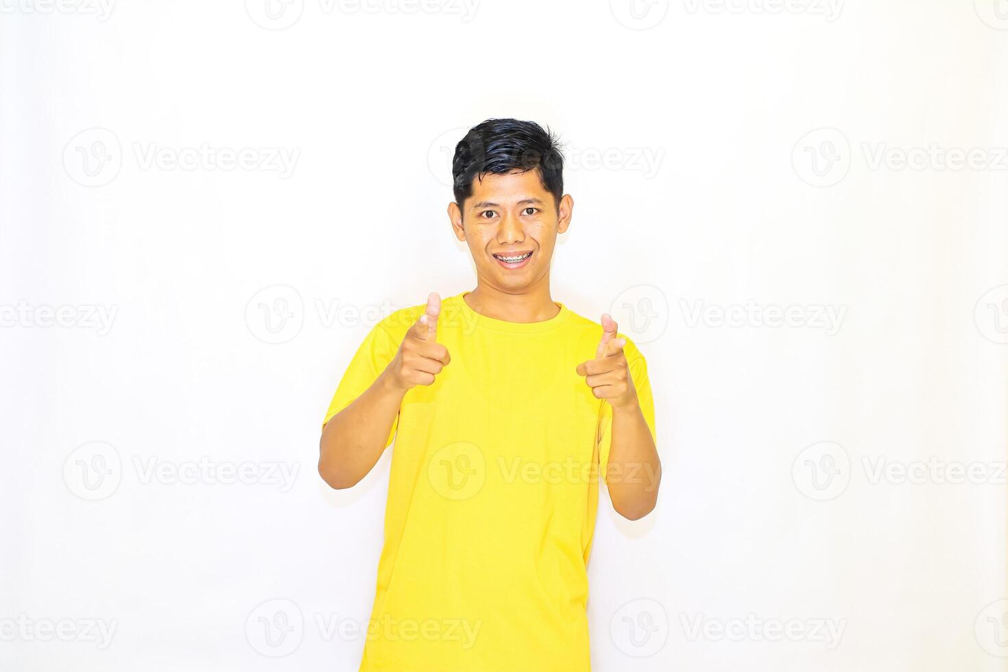 a young man in a yellow shirt is giving the thumbs up photo
