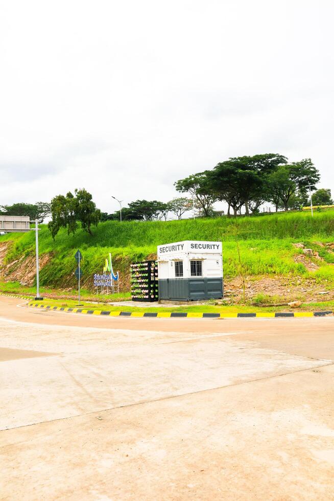 Bakauheni, January 17, 2025, Security booth stands on a green hill with trees photo