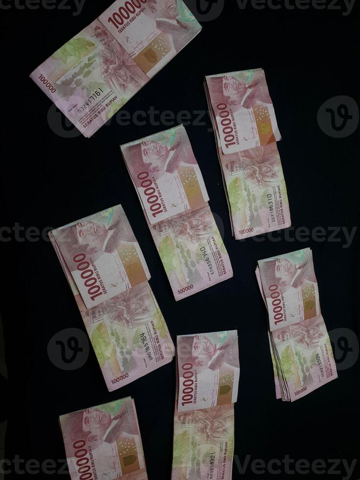 Scattered Indonesian Rupiah Banknotes on a Dark Background Currency Concept photo