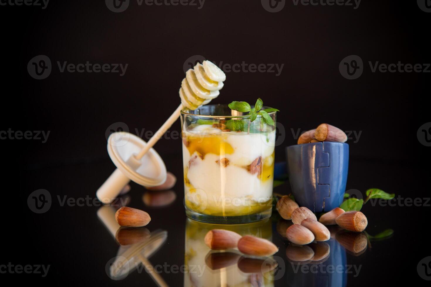 Yogurt with honey and nuts, natural delight. isolated on black background photo