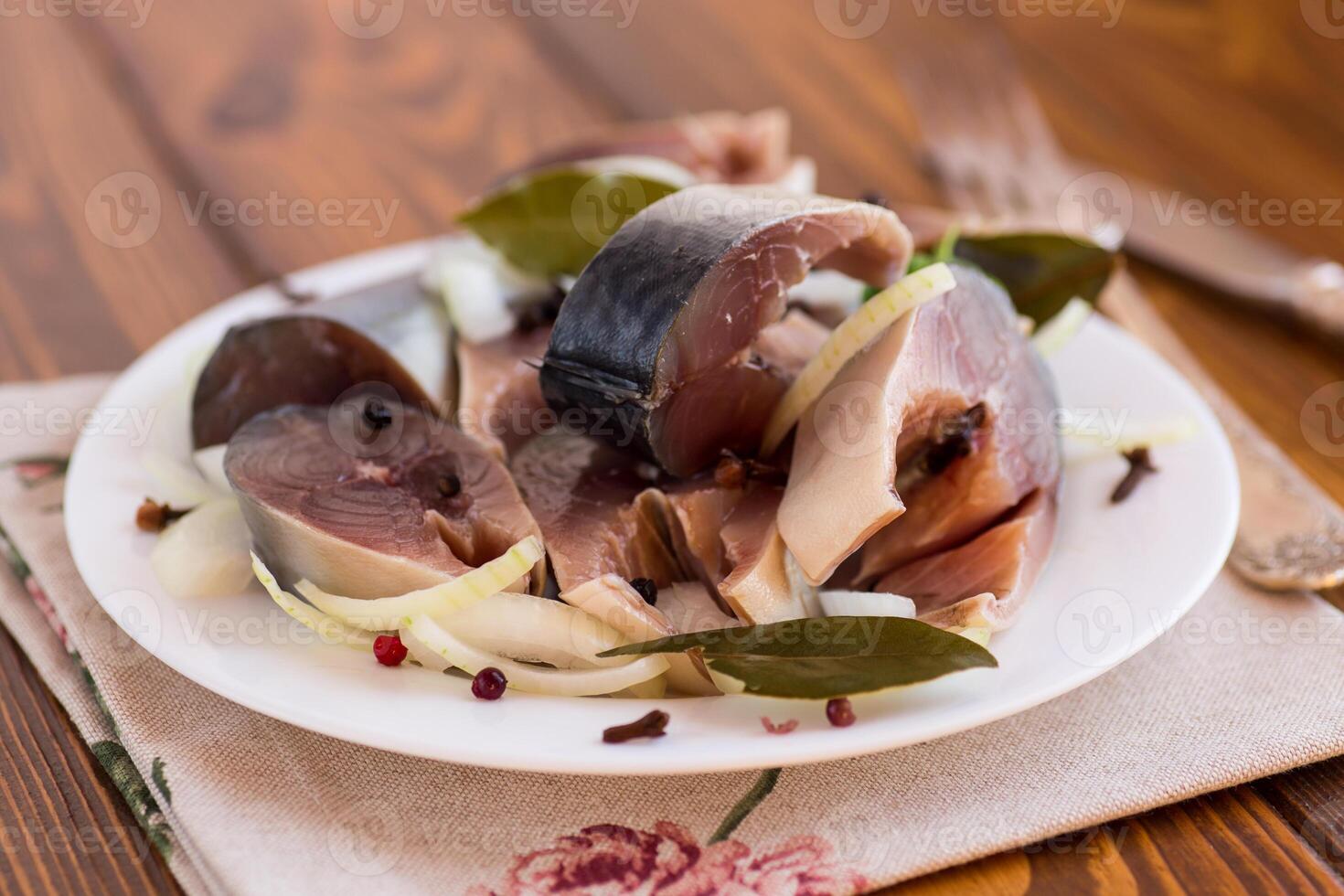 Ideal Cracker . lightly salted mackerel with onions and spices, in a plate photo