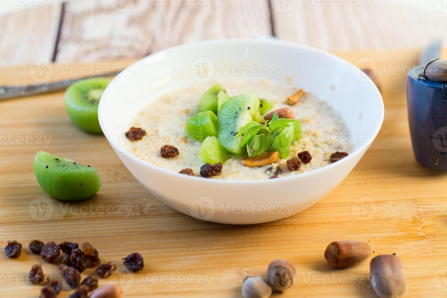 Oatmeal with nuts and kiwi pieces photo