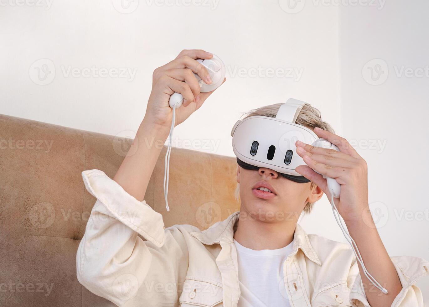Teenager wearing virtual reality headset, at home photo