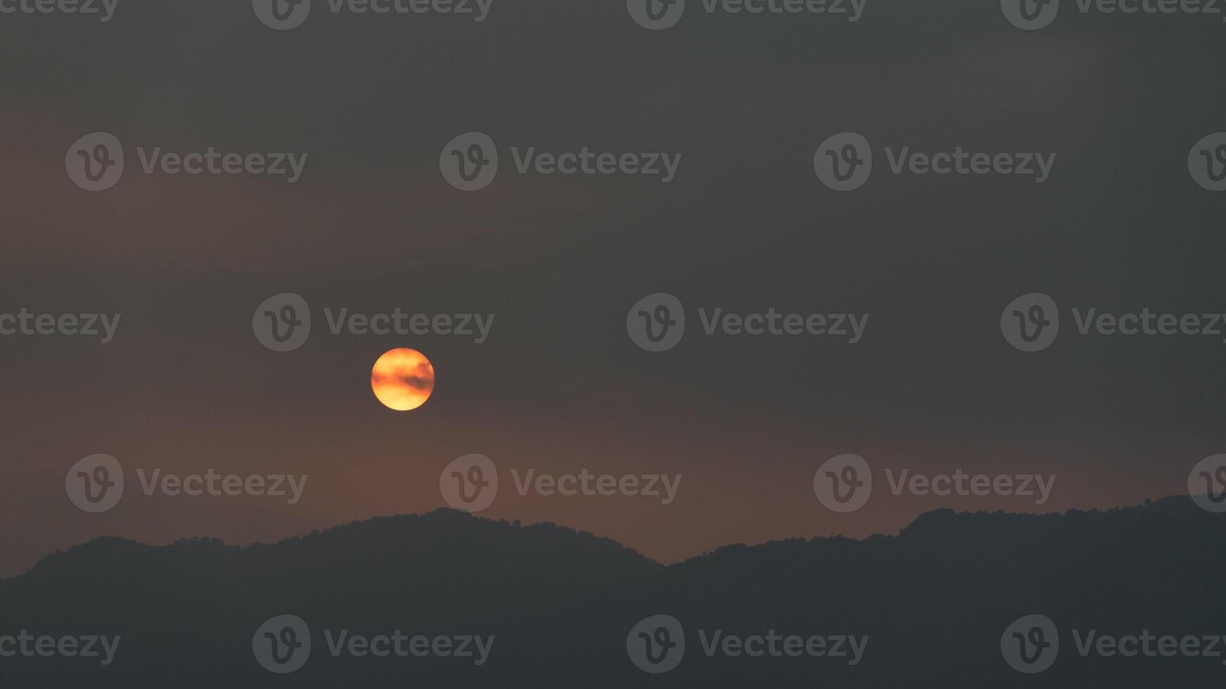 Abstract landscape of mountains with setting sun photo