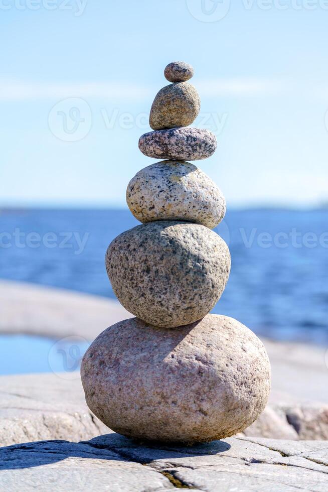 Pyramid of stones. Unstable balance of stone objects. photo