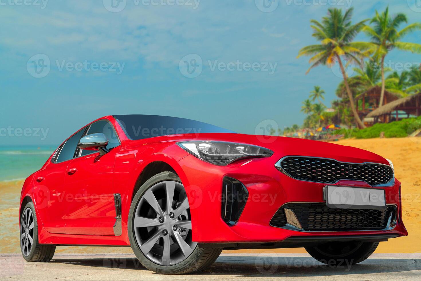Red car on a background of palm trees and blue sky. photo
