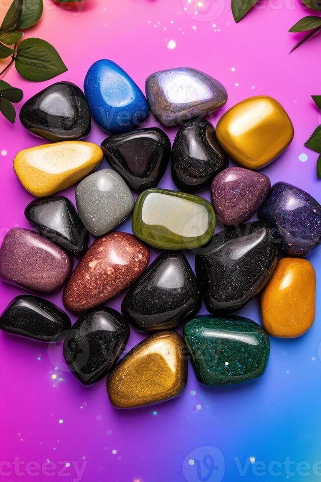Colorful polished gemstones on a vibrant pink and blue gradient background, symbolizing healing and energy balancing, perfect for wellness and spirituality concepts photo