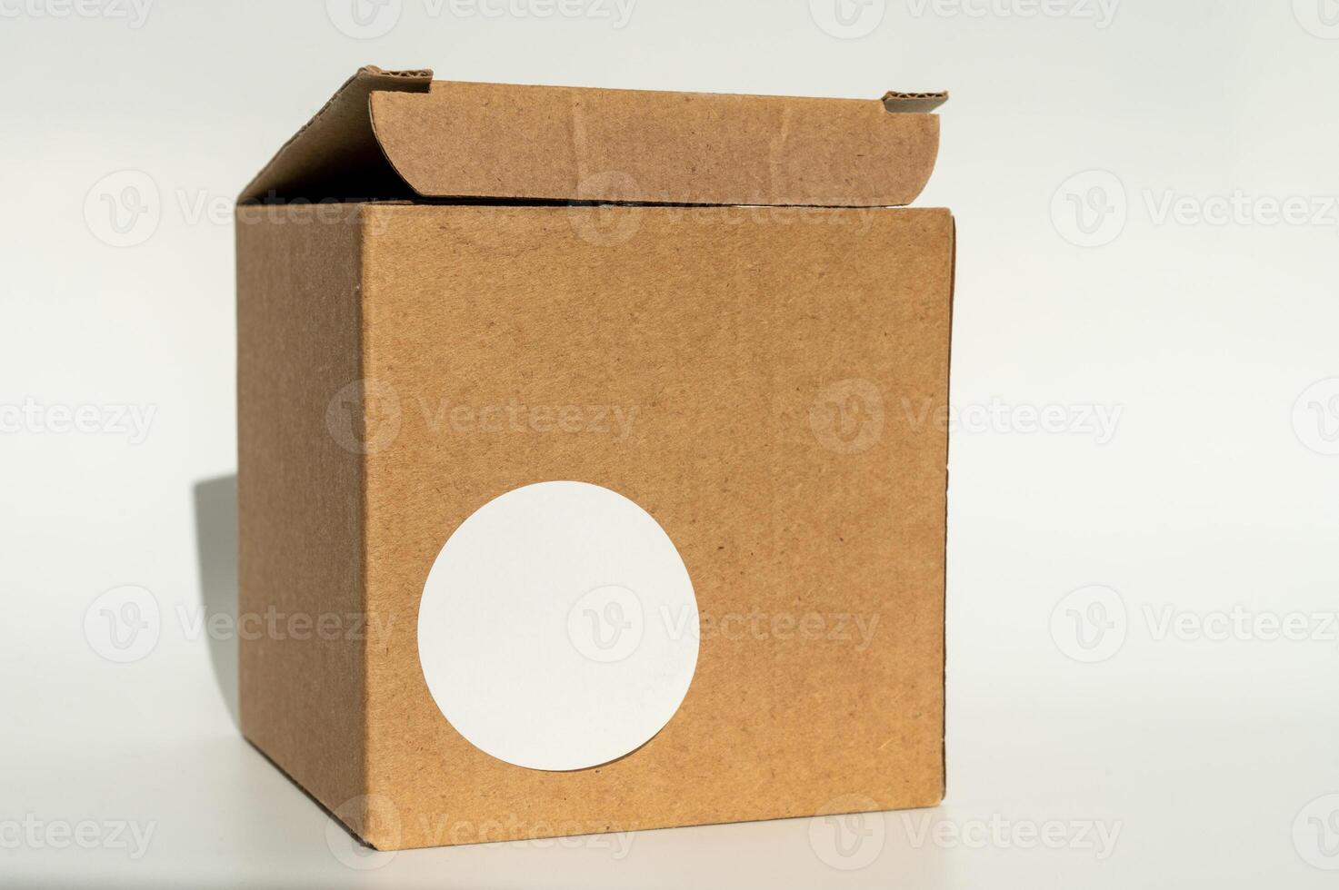 National Cartonnage Day. Cardboard box with white round sticker. Minimal product packaging design photo